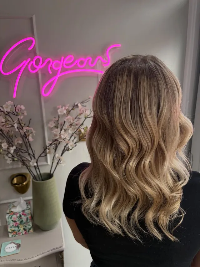 Soft, dimensional blonde balayage with depth kept at the root